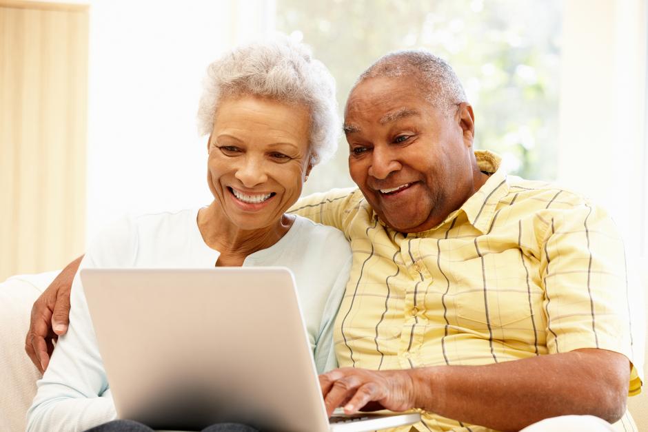 elderly couple using laptop